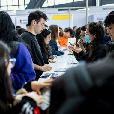 Estudiantes visitando el stand