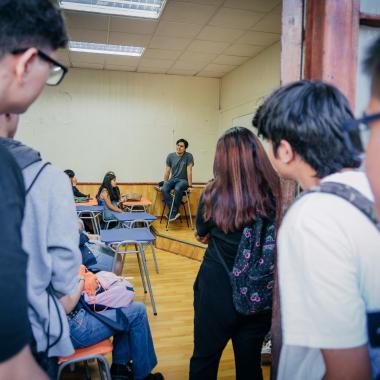 Estudiantes mirando dentro de una sala de clases