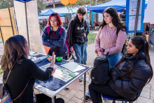 Estudiantes conversando en un estand de información 