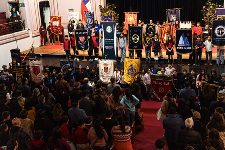 Estudiantes con estandartes de sus colegios en el Aula Magna