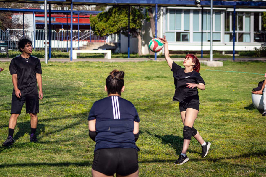 Estudiantes juegan voleibol en los pastos de Ciencia