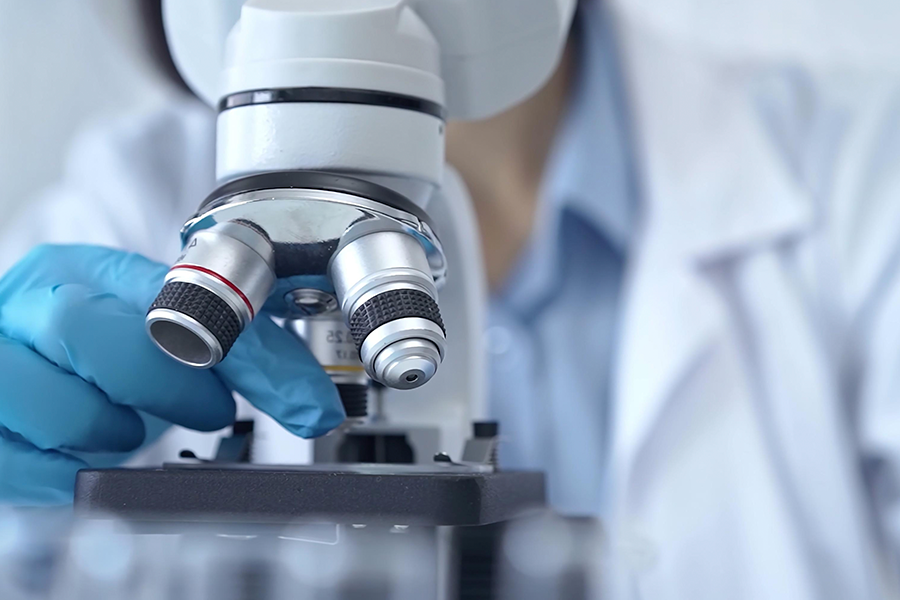 Scientist working with a microscope.