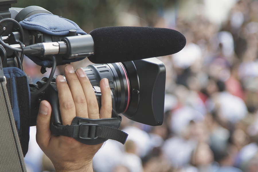 Close-up of a video camera in the hand of an audiovisual professional