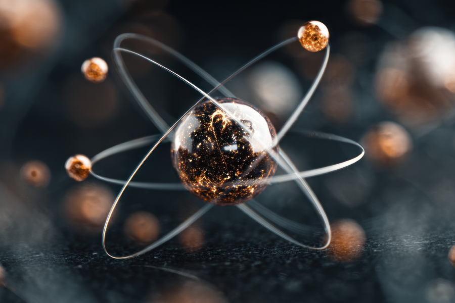 3D atomic model showing glowing electrons orbiting a central nucleus.